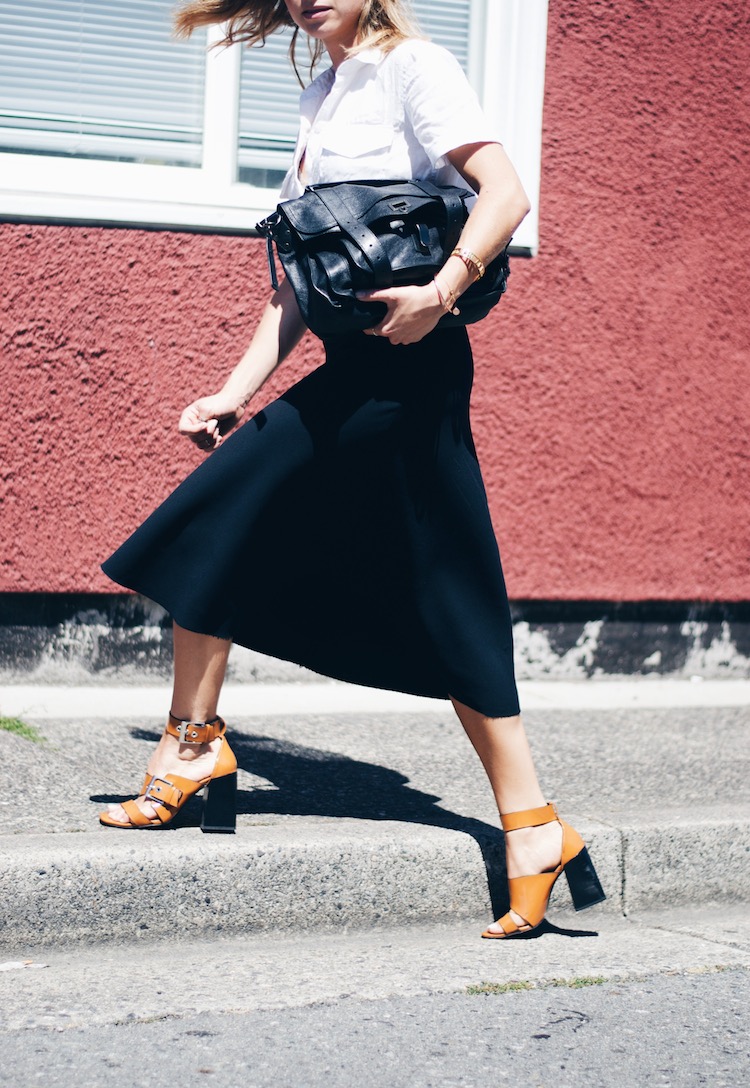 black fluted midi skirt, chunky heeled sandals