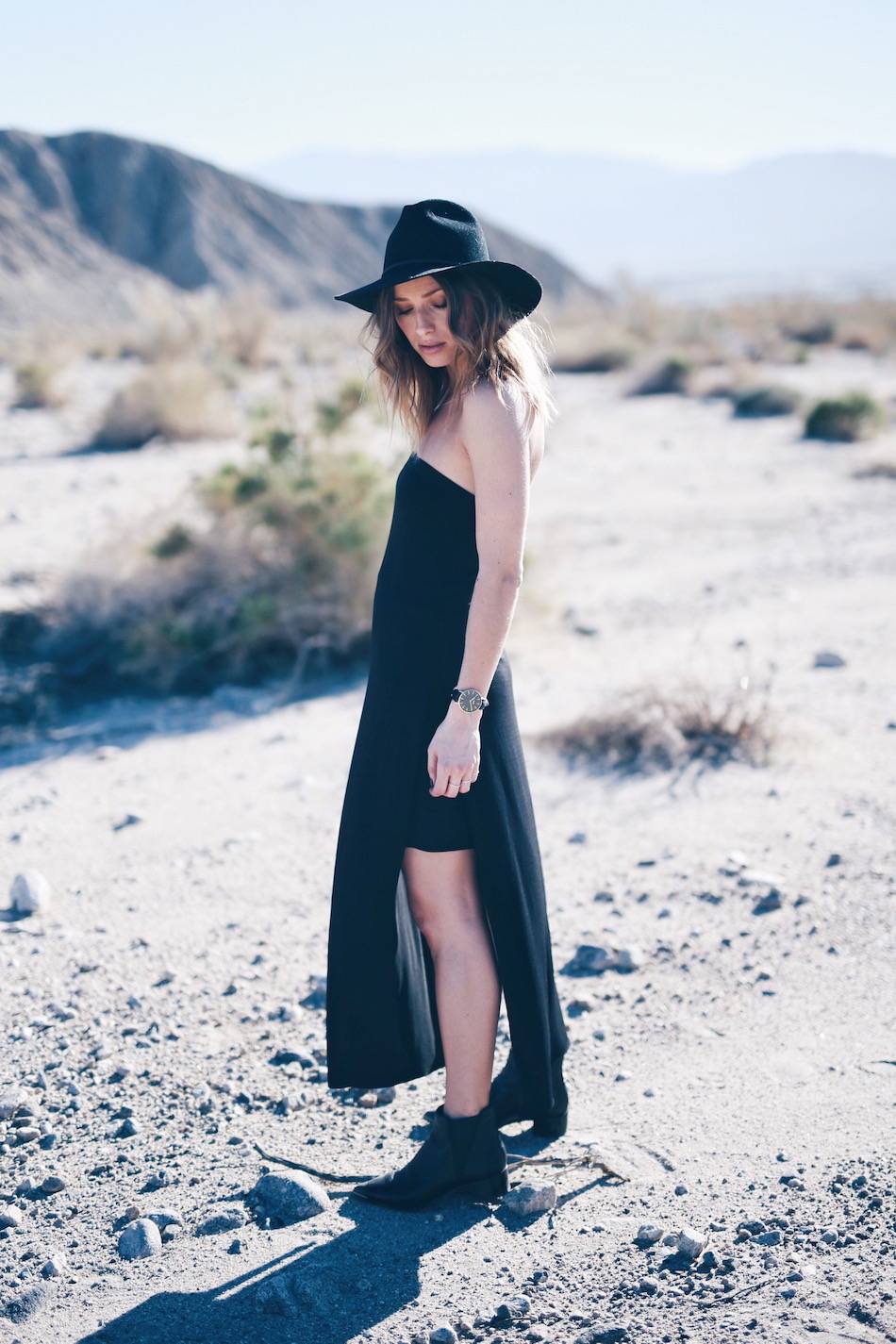 black strapless dress hat and boots in desert