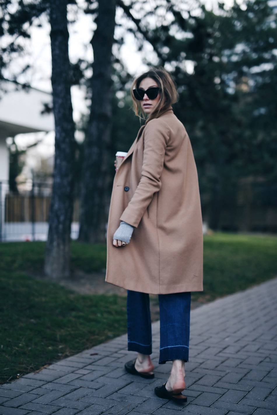 Style and beauty blogger Jill Lansky of The August Diaries in Aritzia camel coat, Rachel Comey jeans, Gucci slide loafers, Celine sunglasses