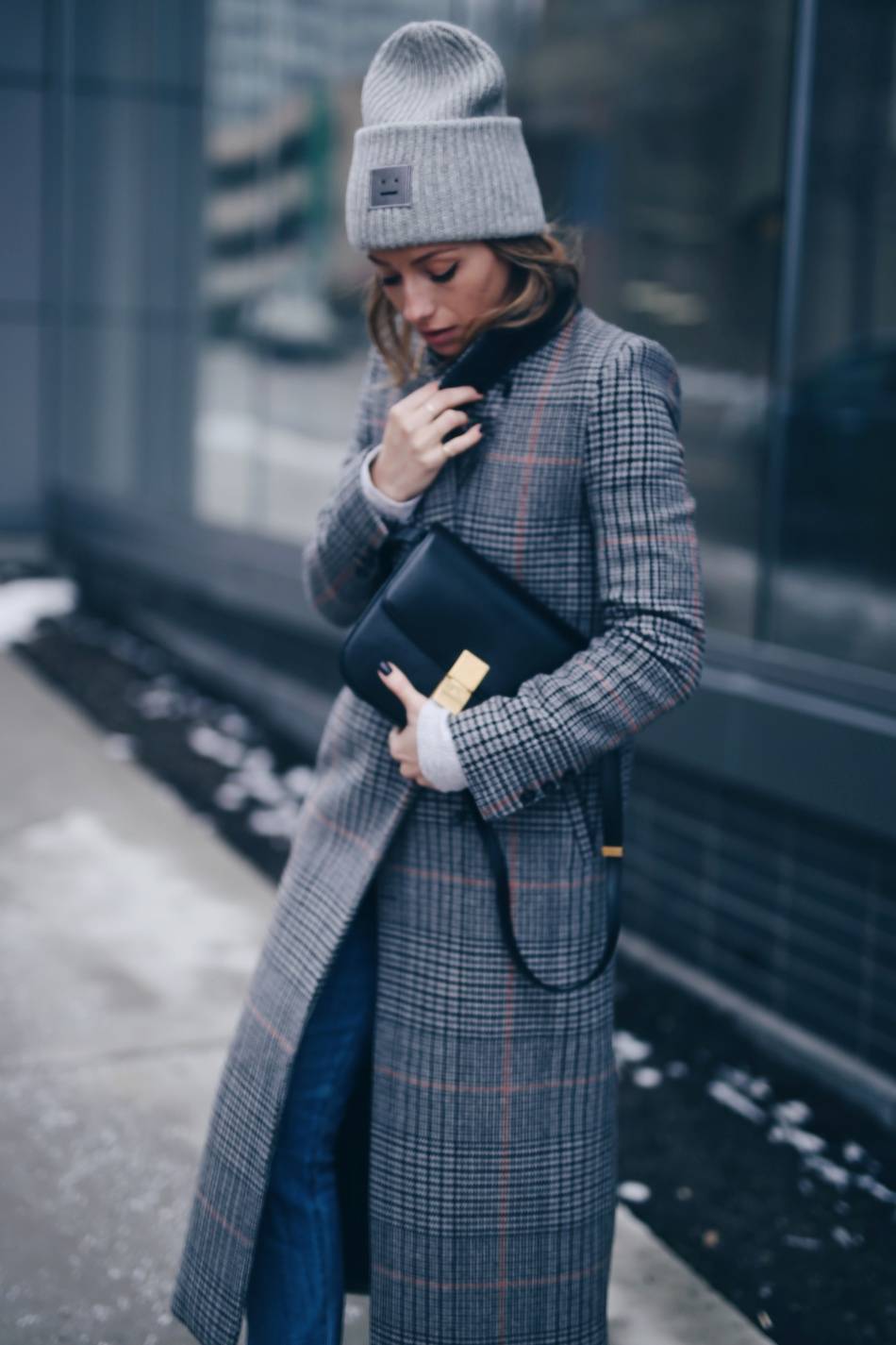 Style and beauty blogger Jill Lansky of The August Diaries on how to stay warm + stylish in the winter in Acne Pansy toque, plaid maxi coat, Celine black box bag