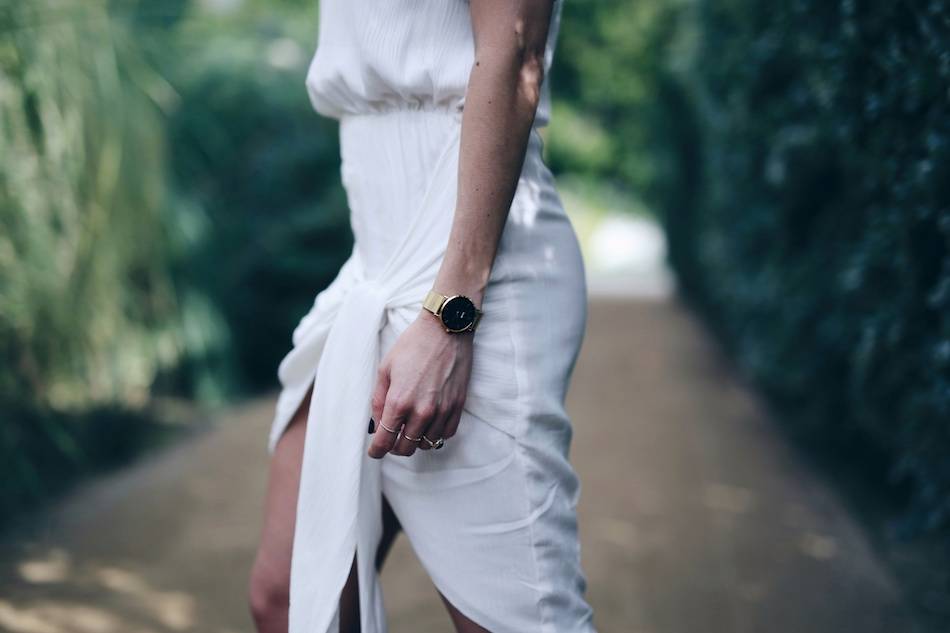 Style and beauty blogger Jill Lansky of The August Diaries what to wear on vacation in white wrap Stylestalker black and gold watch