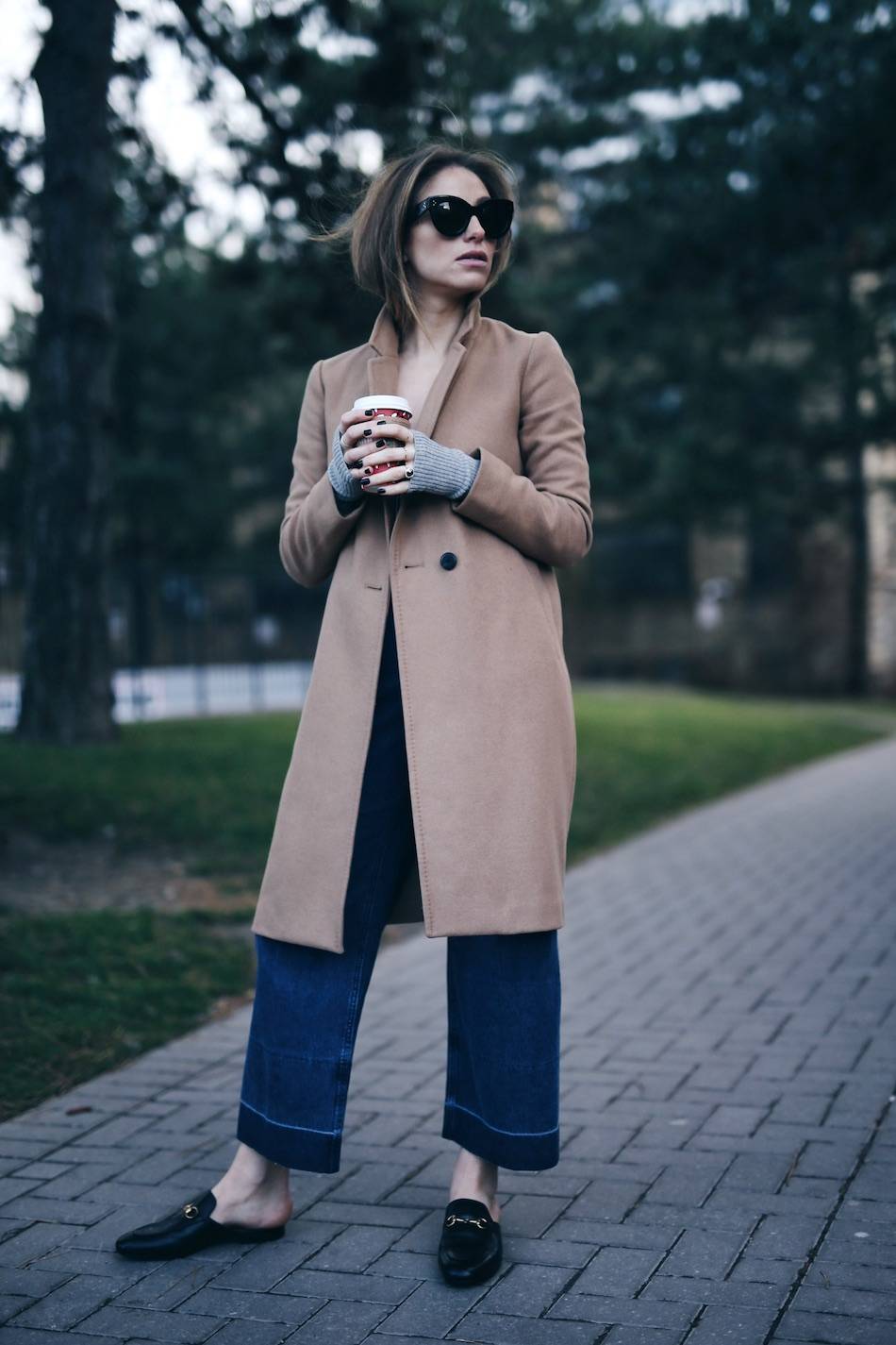 Style and beauty blogger Jill Lansky of The August Diaries in Aritzia camel coat + Gucci slides, Rachel Comey jeans, Celine Caty sunglasses