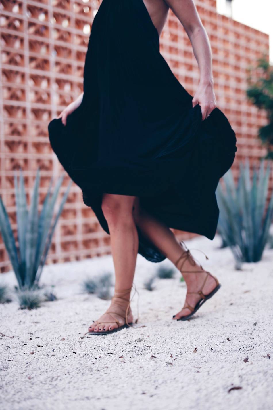 Style and beauty blogger Jill Lansky of The August Diaries on what to wear to dinner on vacation in Aritzia black maxi dress and Madewell leather gladiator sandals 