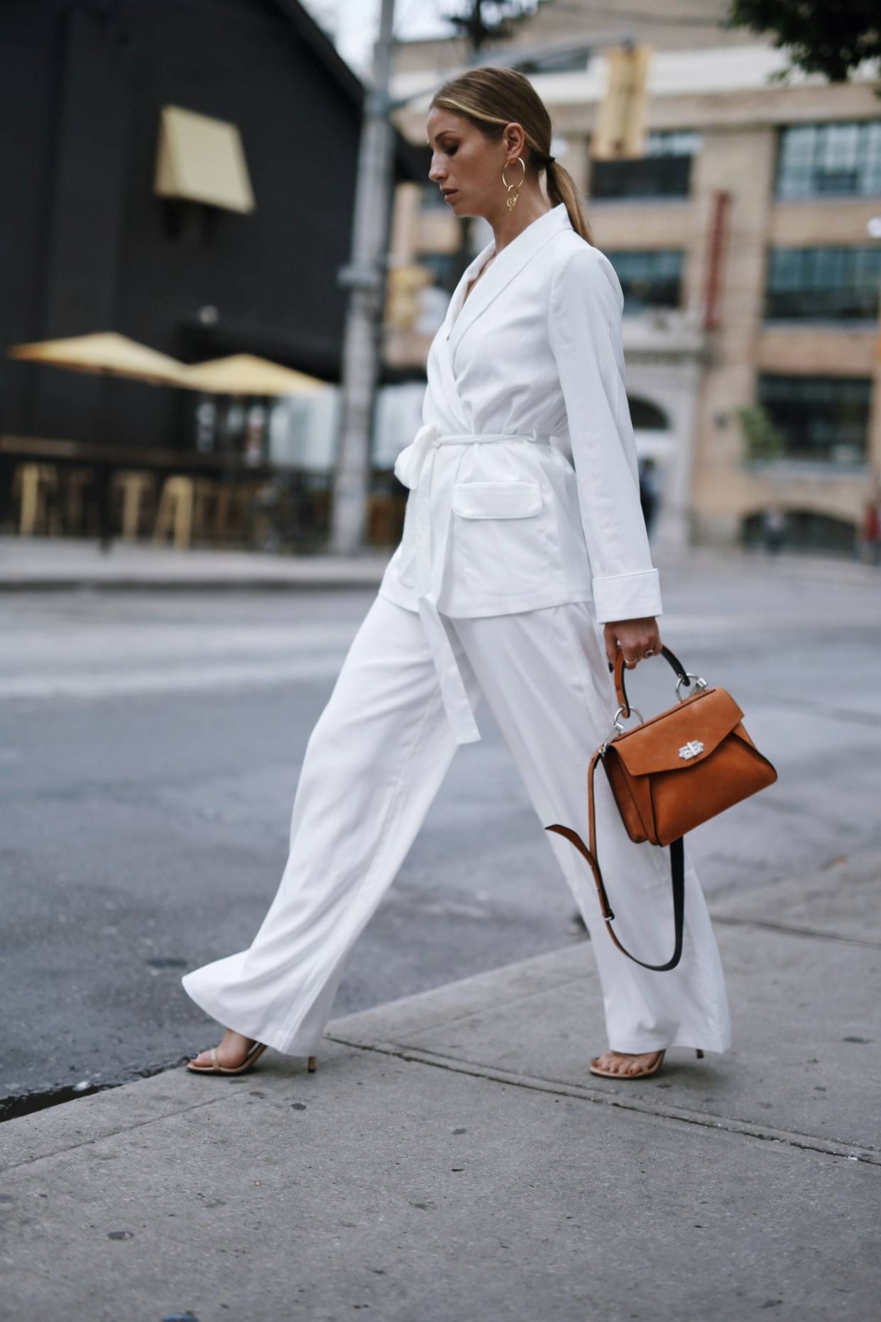 Style and beauty blogger Jill Lansky of The August Diaries wearing a white silk suit, brown proenza schouler bag
