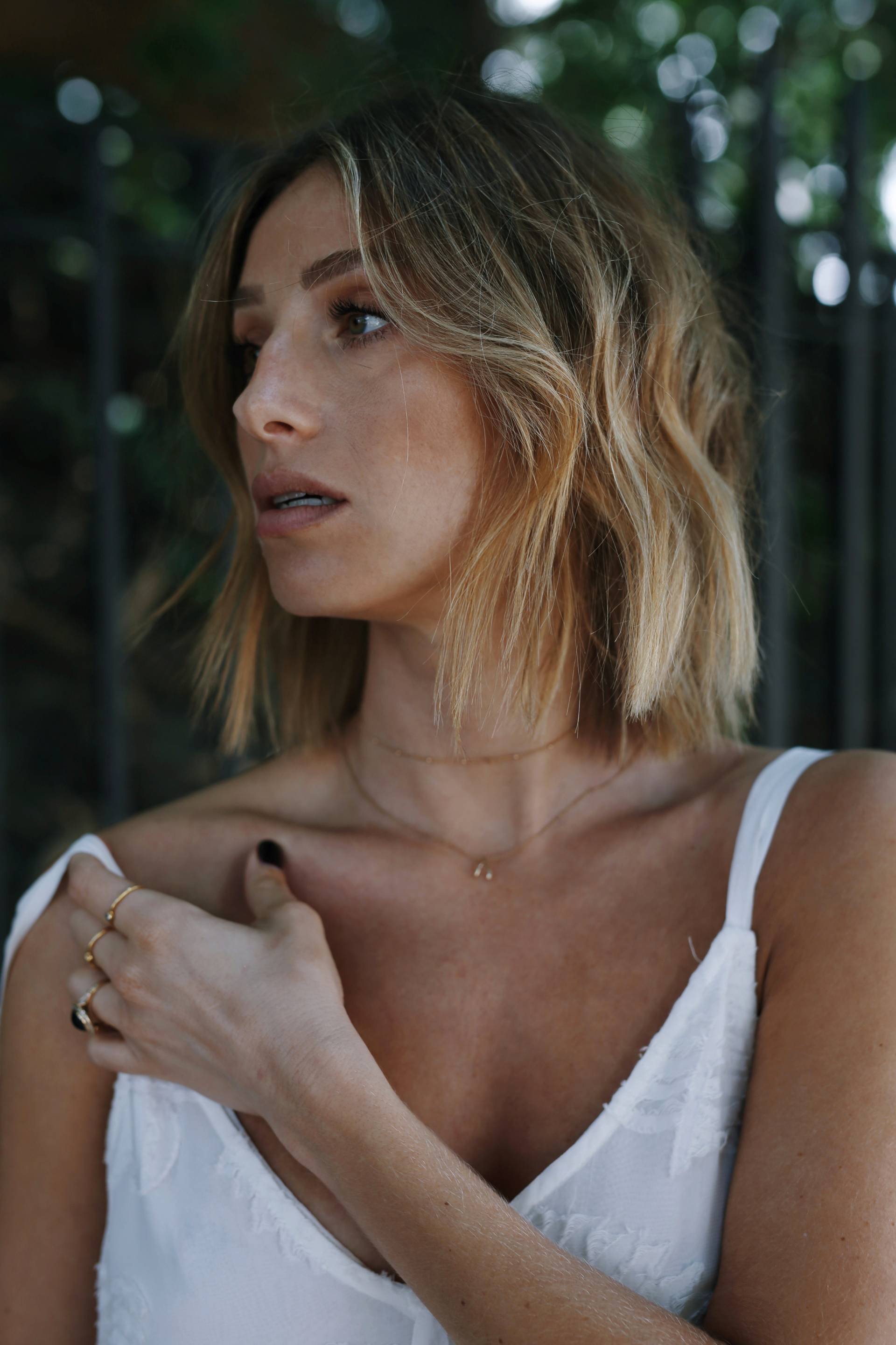 Style and beauty blogger Jill Lansky of The August Diaries on how to save money on a wedding in a second hand Aritzia white dress, long blonde bob, beachy waves