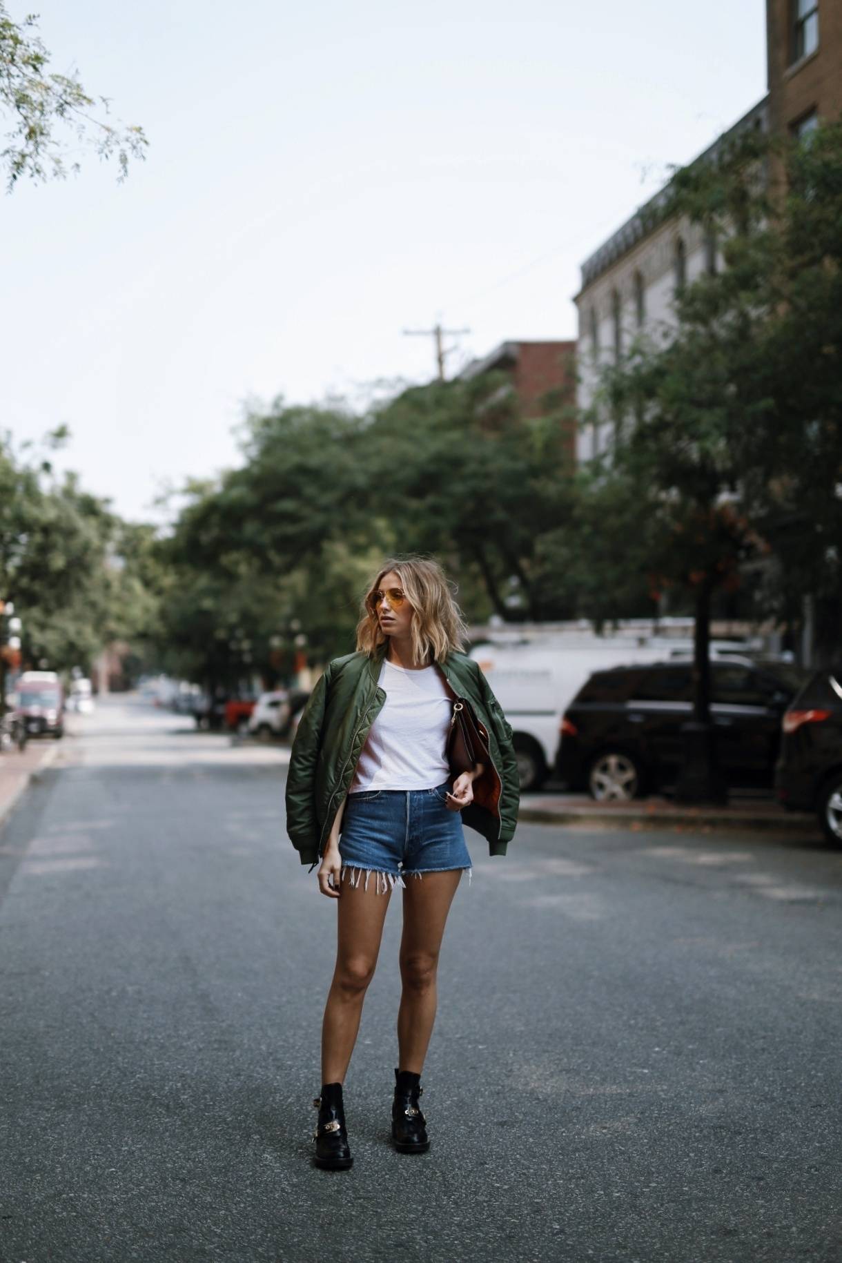 Style and beauty blogger Jill Lansky of The August Diaries on how to mix comfort and style in Alpha Industries bomber jacket, Balenciaga boots, denim shorts