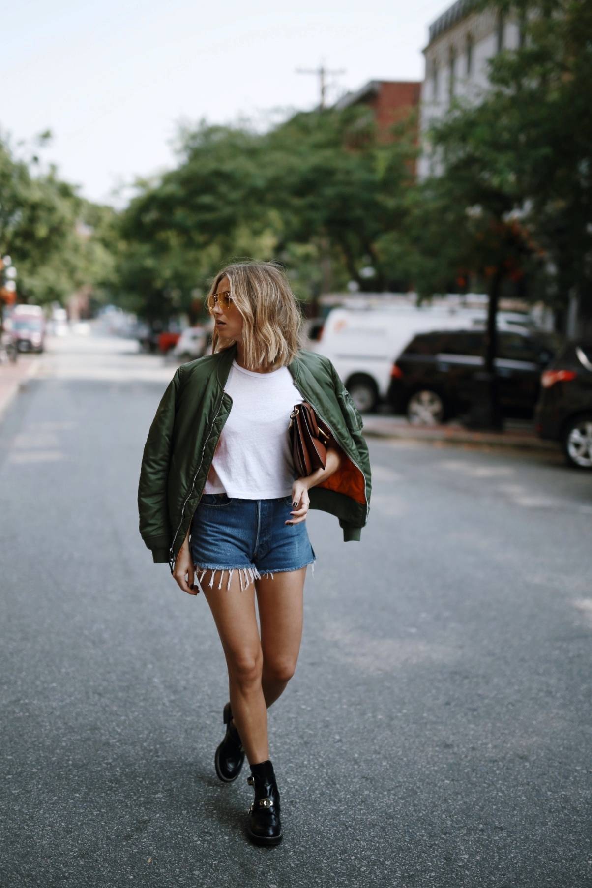 Style and beauty blogger Jill Lansky of The August Diaries on how to mix comfort and style in Alpha Industries bomber jacket, Balenciaga boots, denim shorts, JW anderson bag