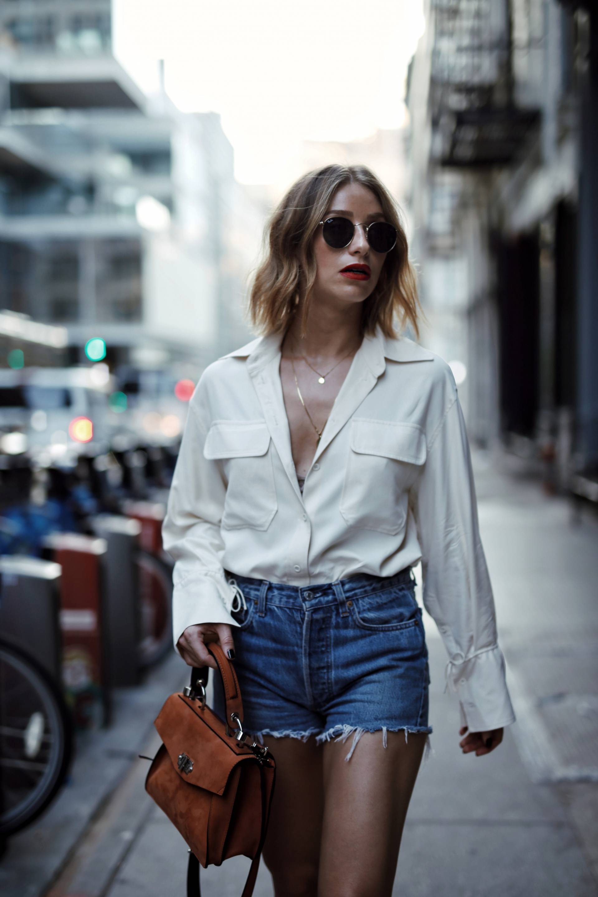 Style and beauty blogger Jill Lansky of the August Diaries on how to dress outside your comfort zone in Aritzia blouse, levi's shorts, proenza schouler hava bag