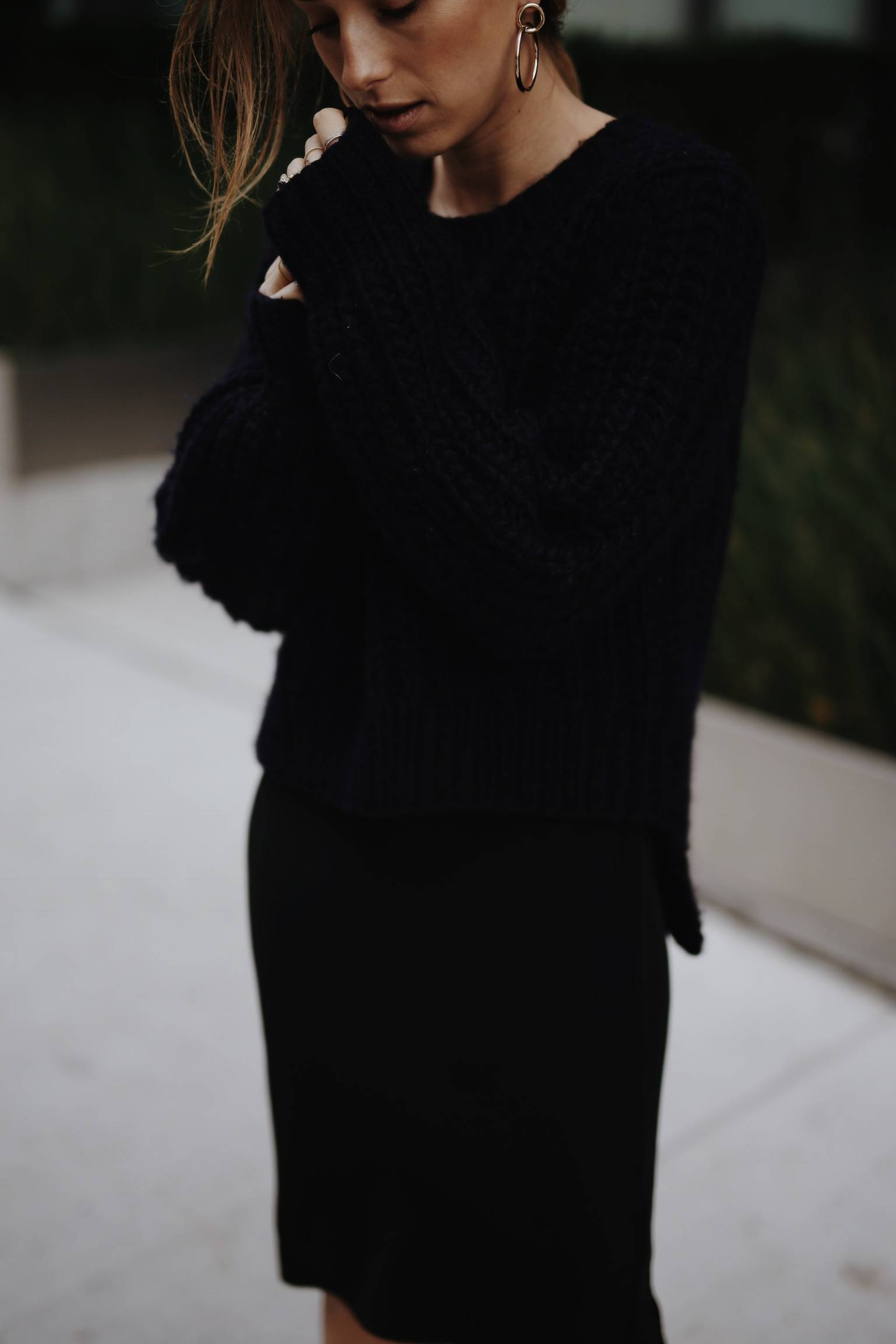 Style and beauty blogger Jill Lansky of The August Diaries shows how to wear black and navy together in a black slip dress and navy knit