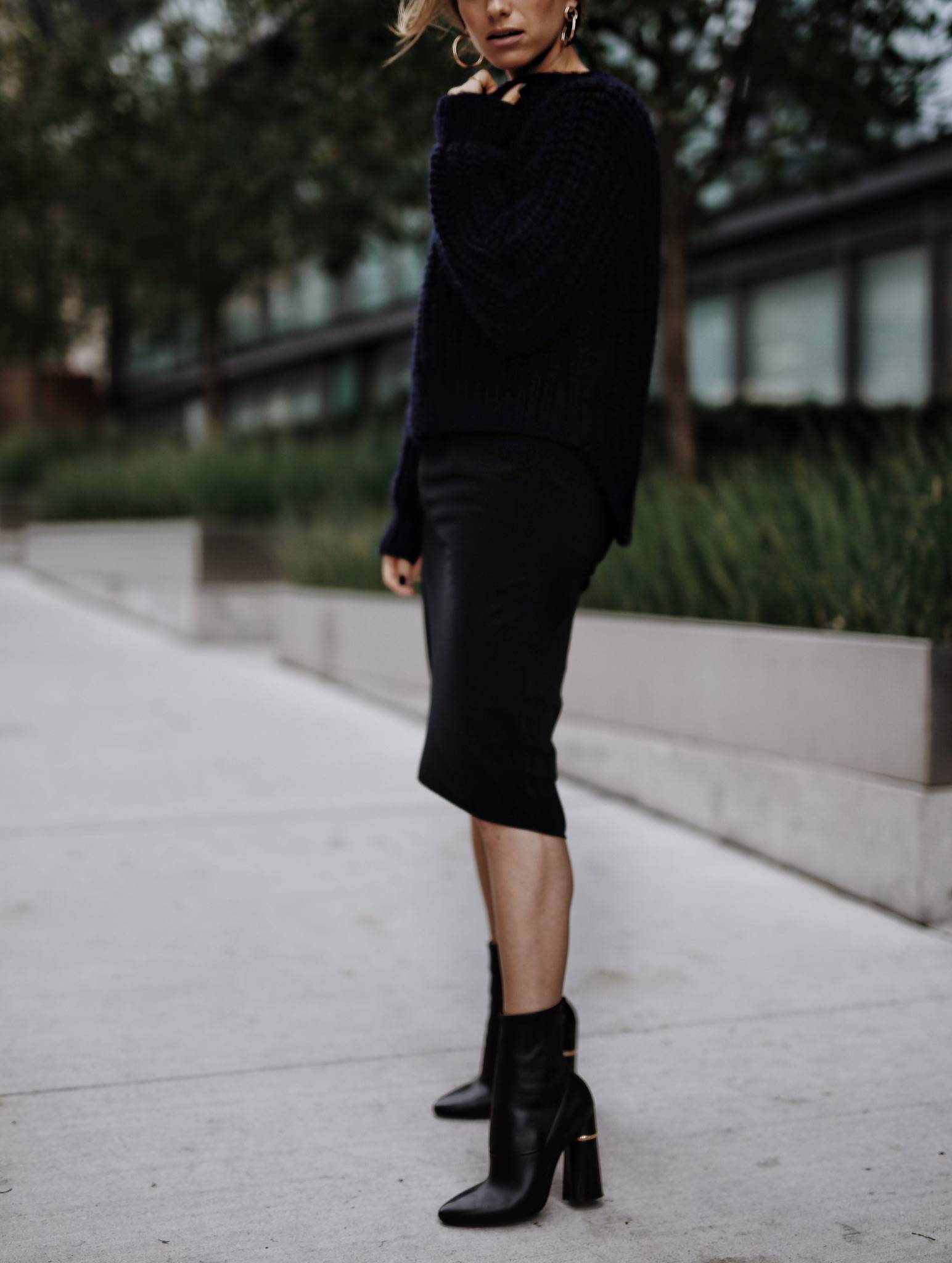 Style and beauty blogger Jill Lansky of The August Diaries shows how to wear black and navy together in a black slip dress and navy sweater with 3.1 Phillip Lim Kyoto boots